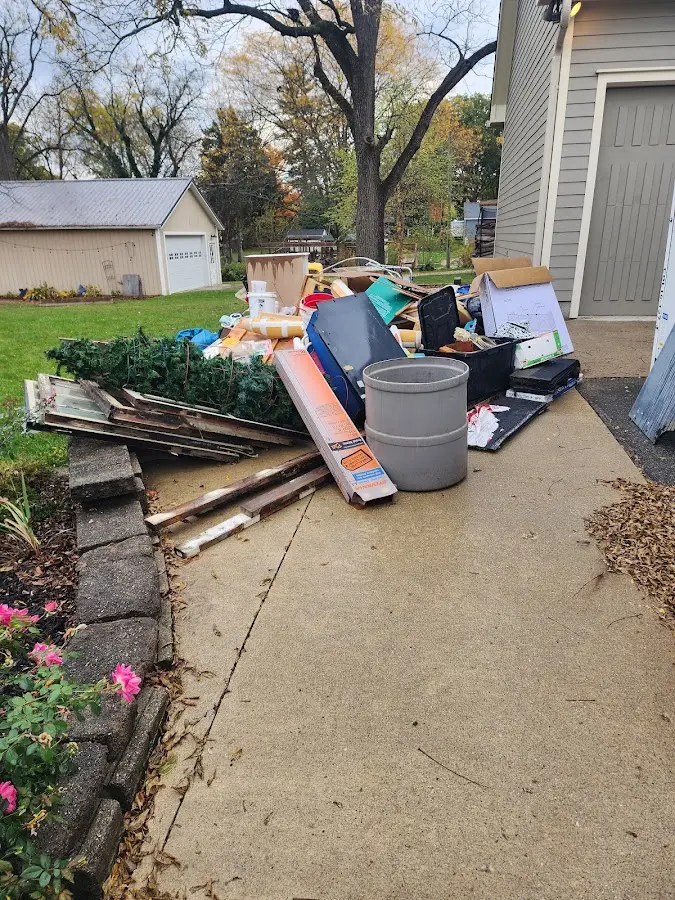 Dumpster being loaded with debris for Residential Dumpster Rental in Eagle Point